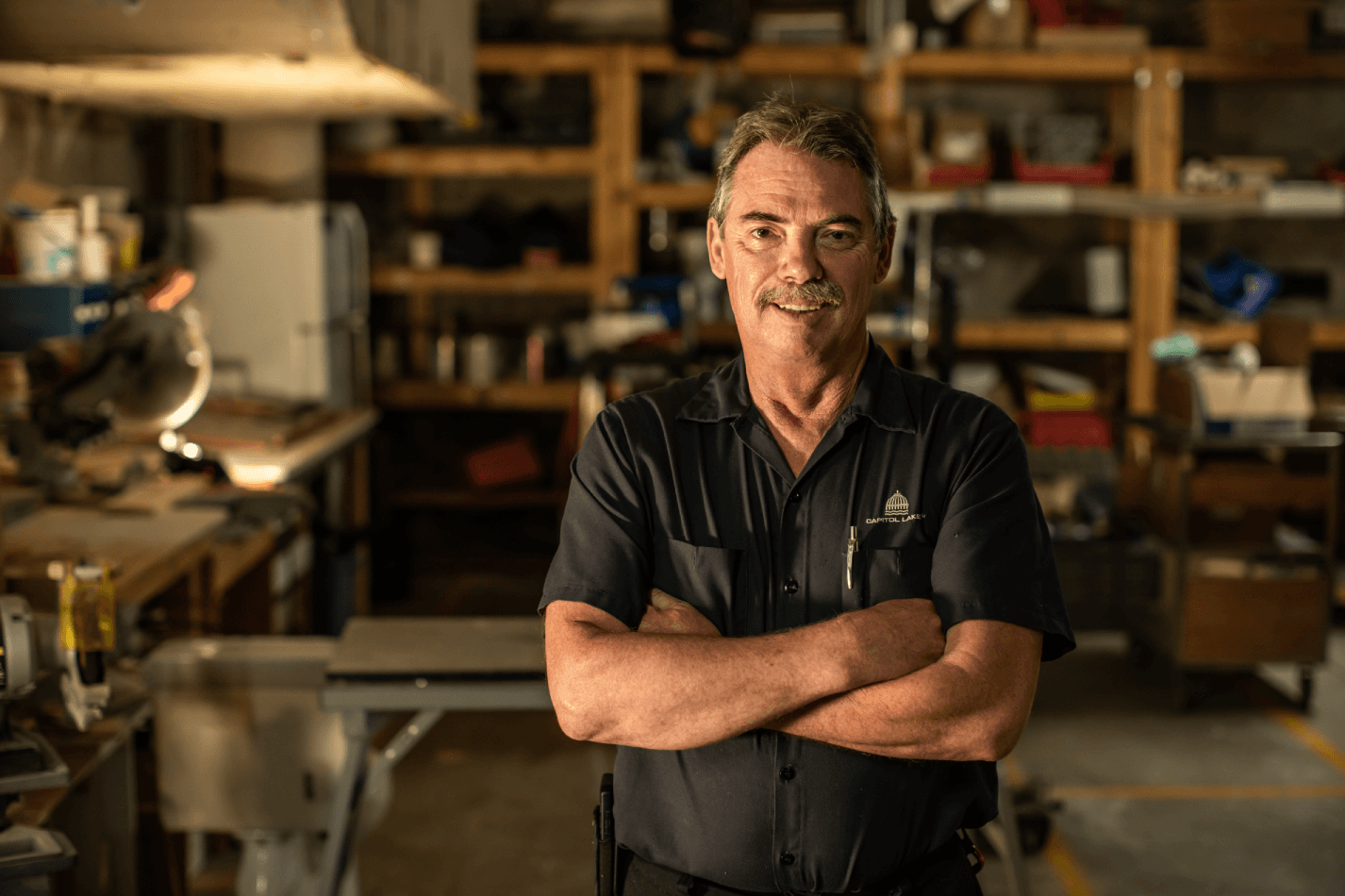 A Capitol Lakes employee stands in a workshop.